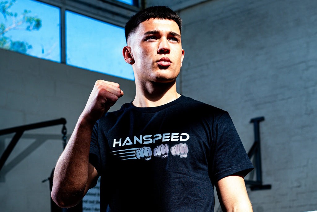 Person wearing a black 'Hanspeed' t-shirt in a gym setting